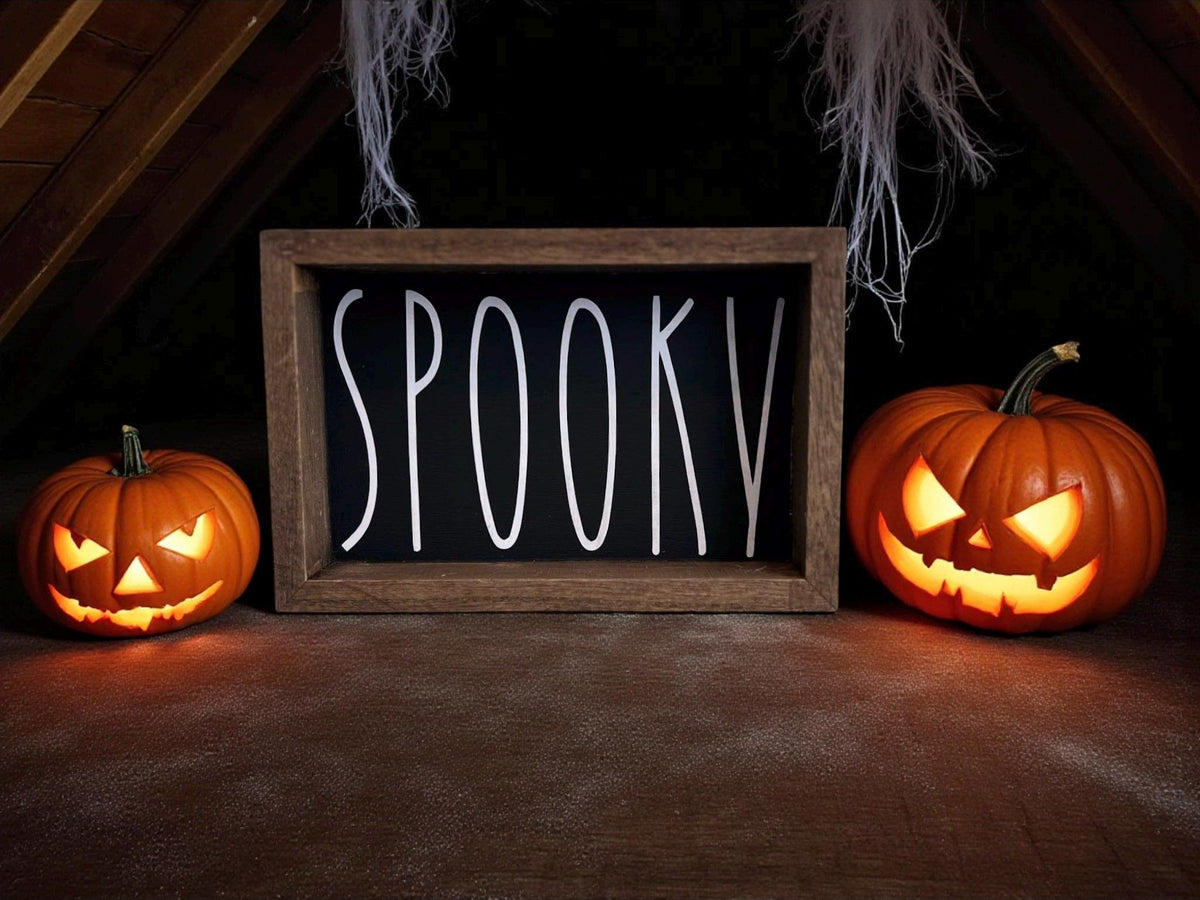 Spooky black sign on weathered wood porch with carved pumpkin