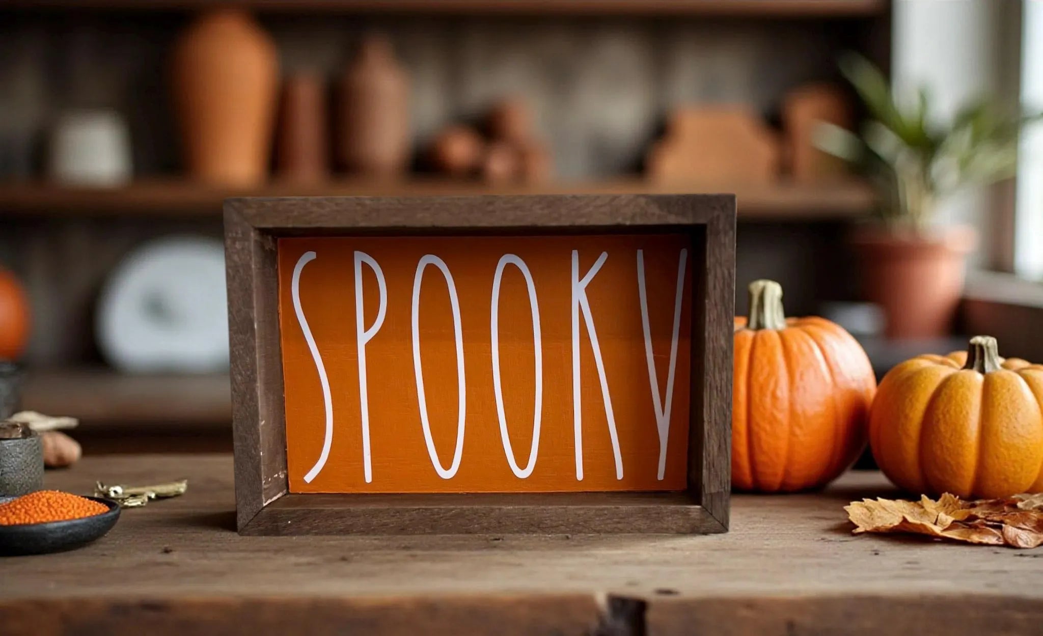 Spooky sign close up on weathered wood with autumn leaves
