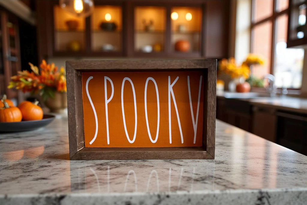 Spooky sign surrounded by orange pumpkins on rustic barn wood table