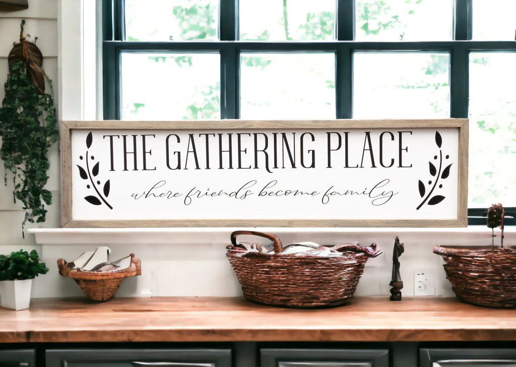 The Gathering Place where friends become family framed farmhouse sign on marble kitchen island counter with modern farmhouse kitchen background