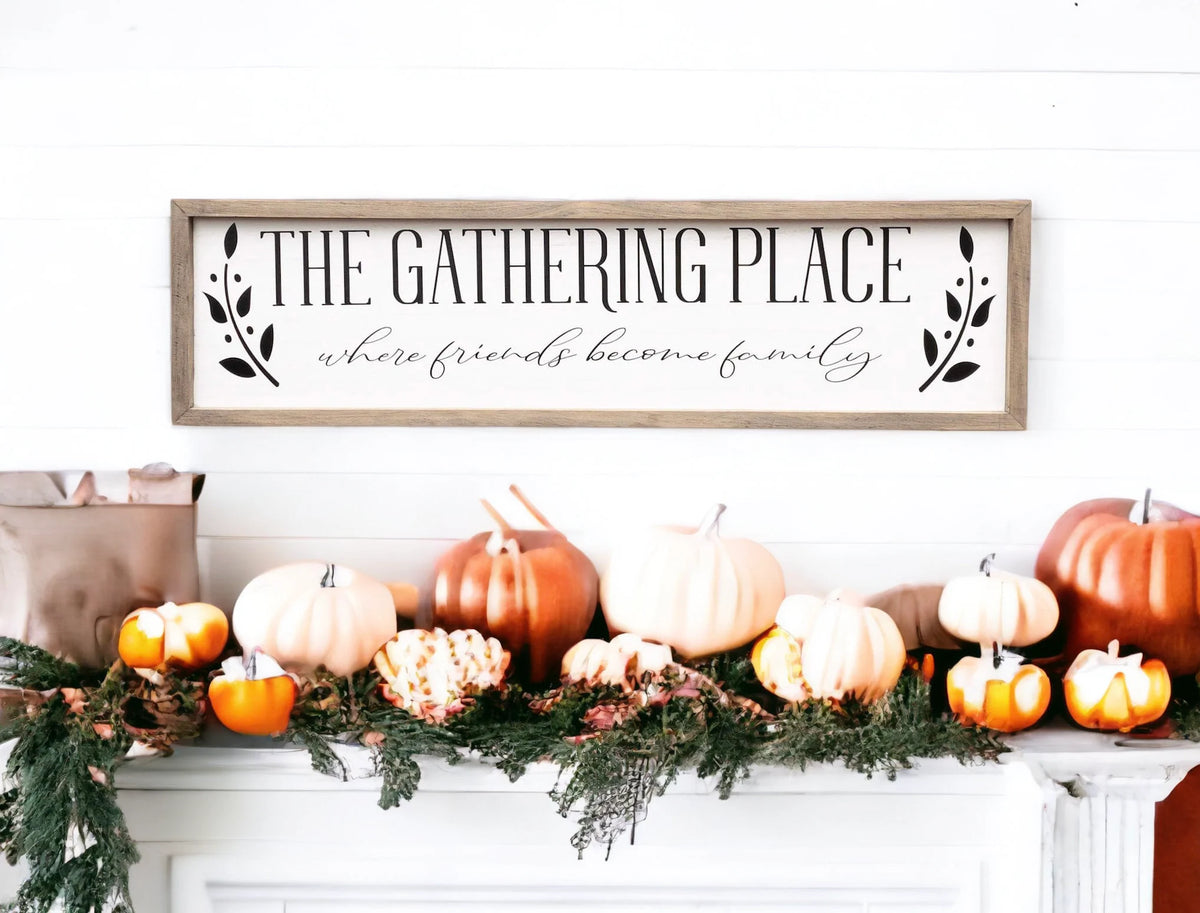 The Gathering Place where friends become family framed farmhouse sign on dark green window kitchen background with wicker baskets on counter
