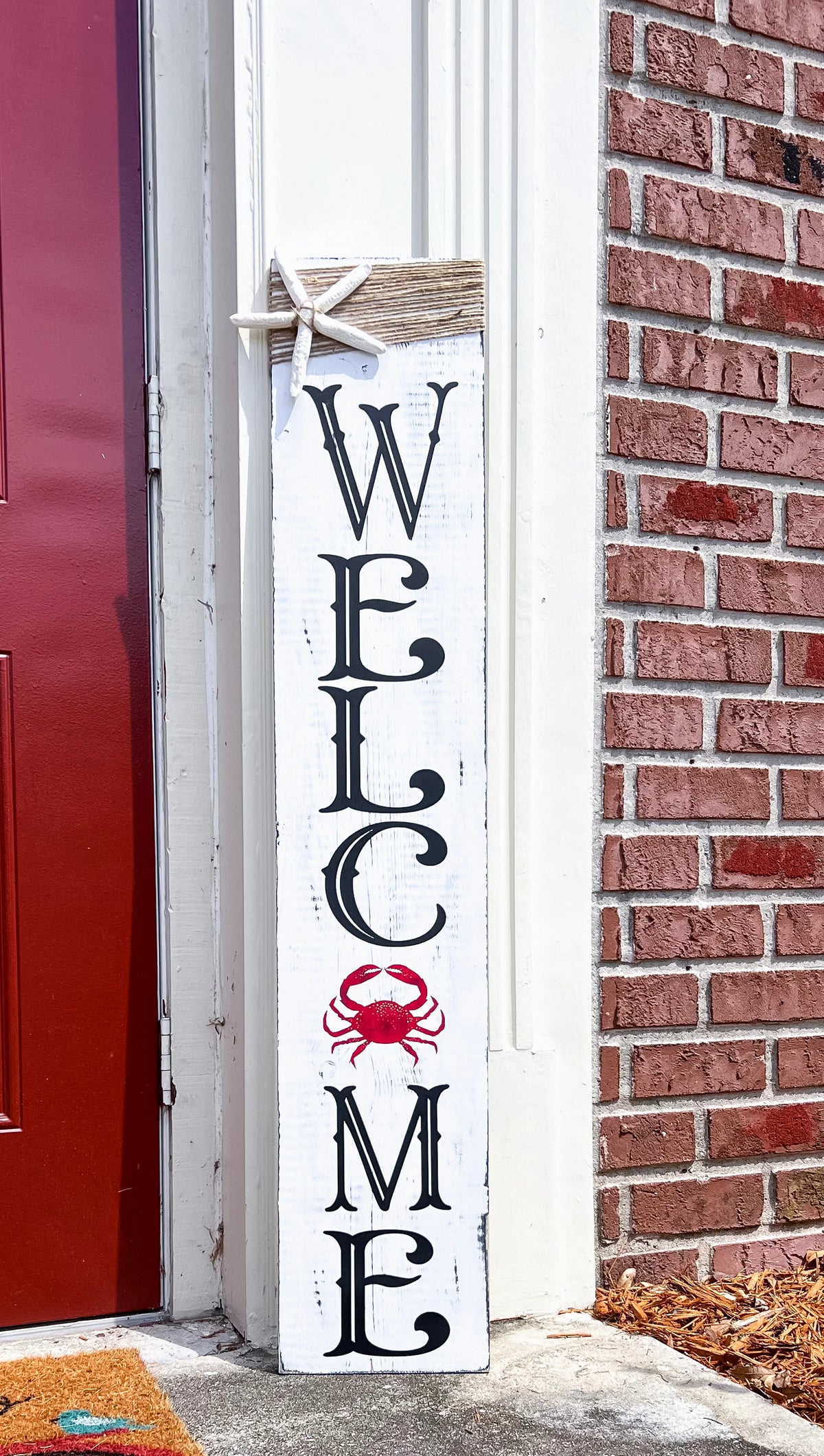 Crab Welcome porch leaner styled on front porch with welcome mat and potted plants