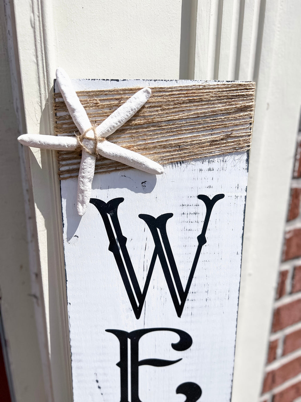 Crab Welcome porch leaner full view on white door with brick wall
