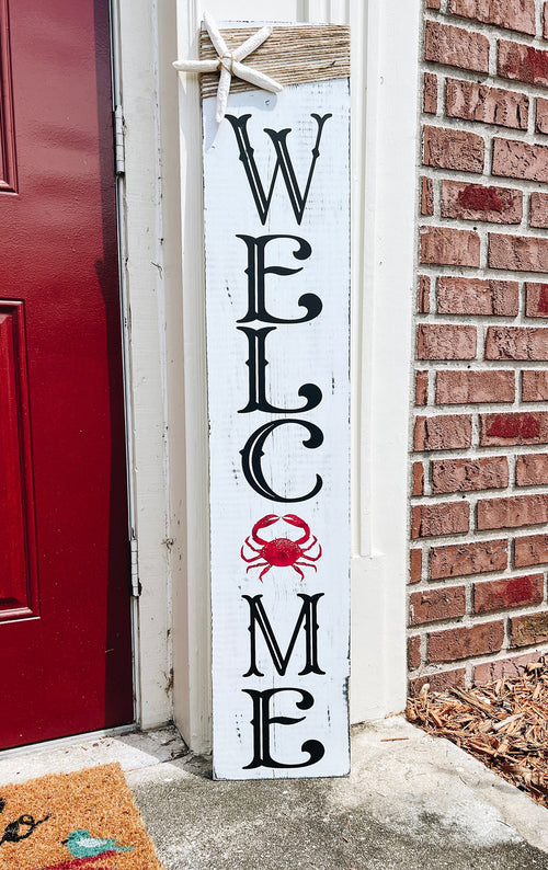 Crab Welcome porch leaner full view leaning against red front door with brick wall