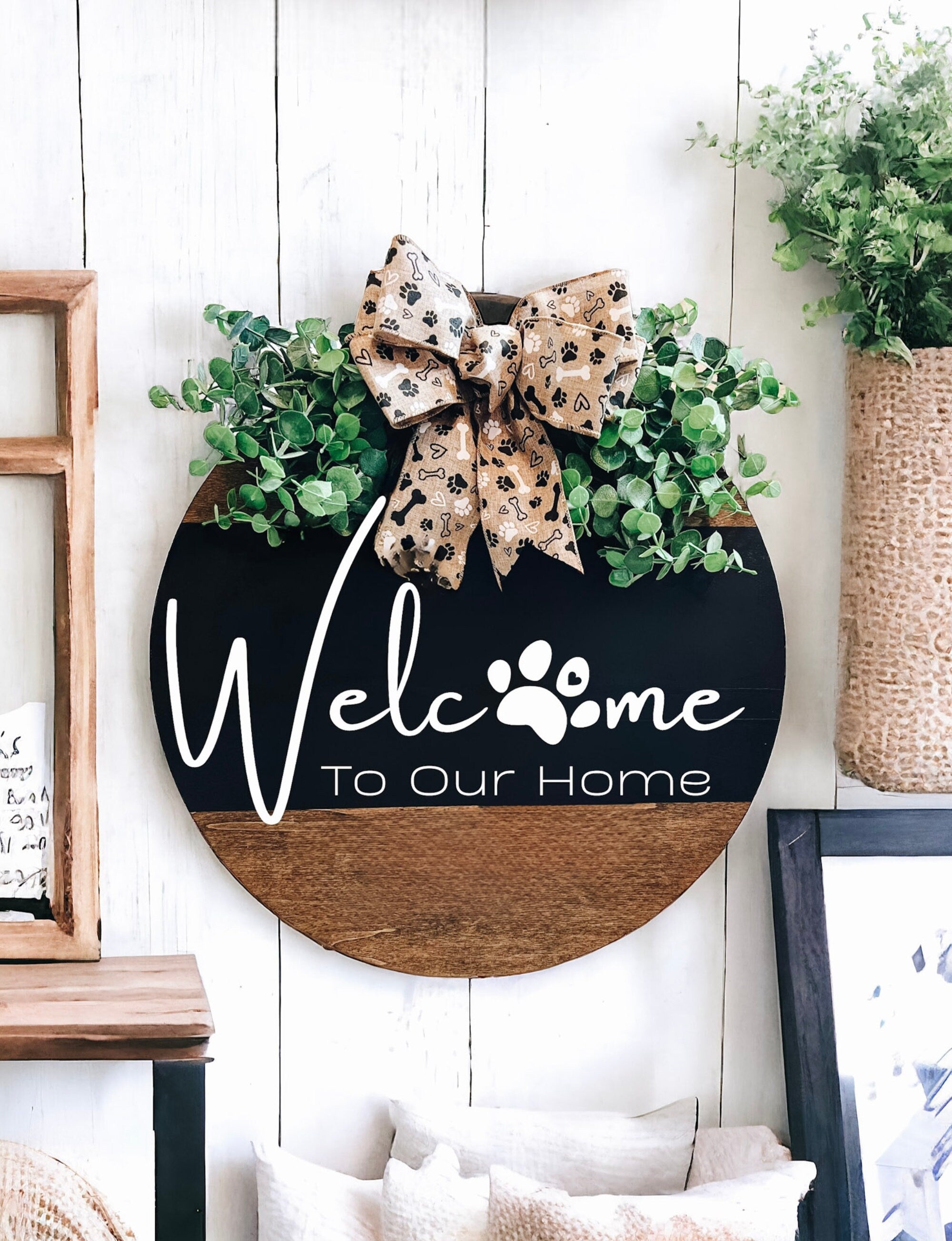 Welcome To Our Home door hanger on black front door with flower pots