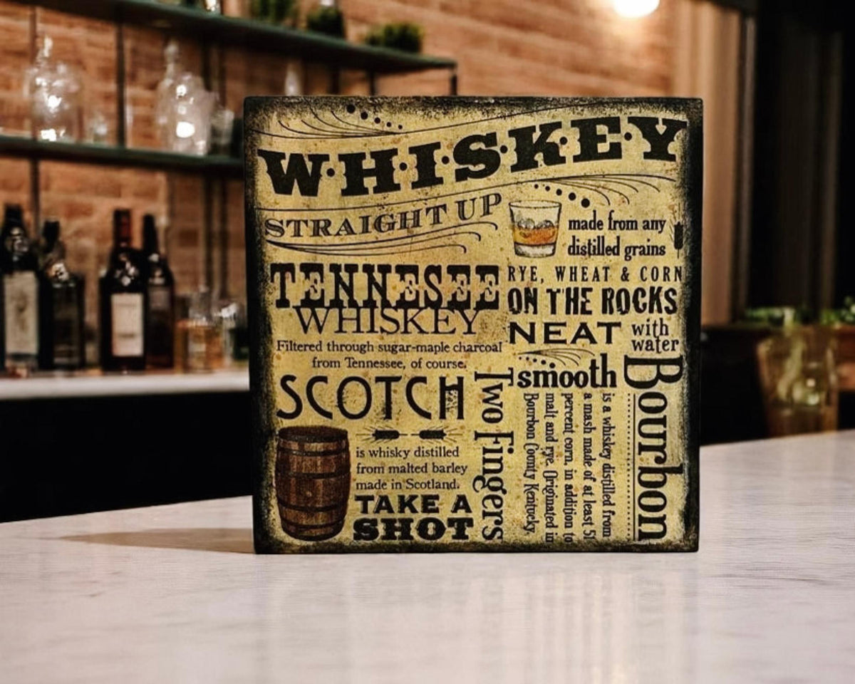 Whiskey wood block sign on wood table with copper still and window light in background