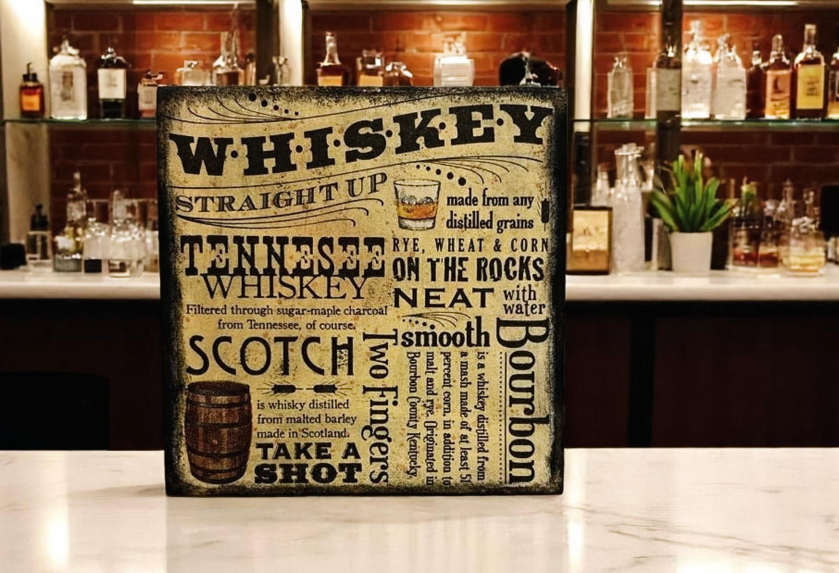 Whiskey wood block sign on rustic wood surface with copper still and mason jars in background