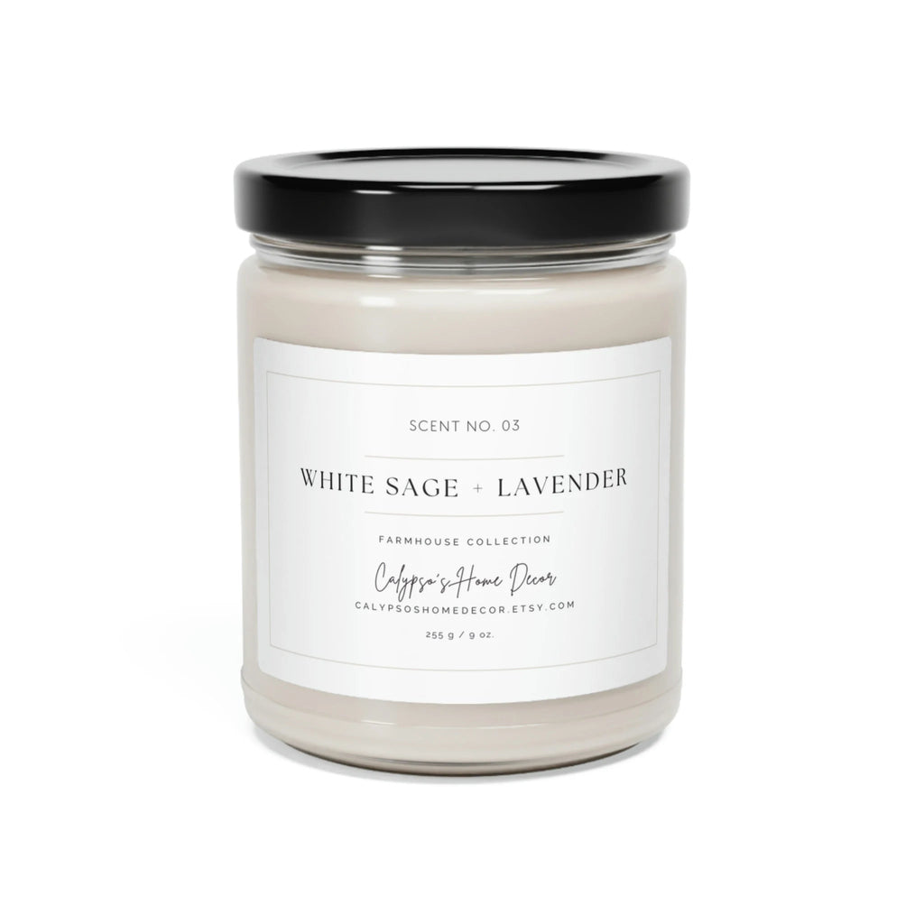 White Sage + Lavender soy candle Scent No. 03 lit in clear glass jar with black lid on rustic wood surface with purple lavender flowers bokeh background